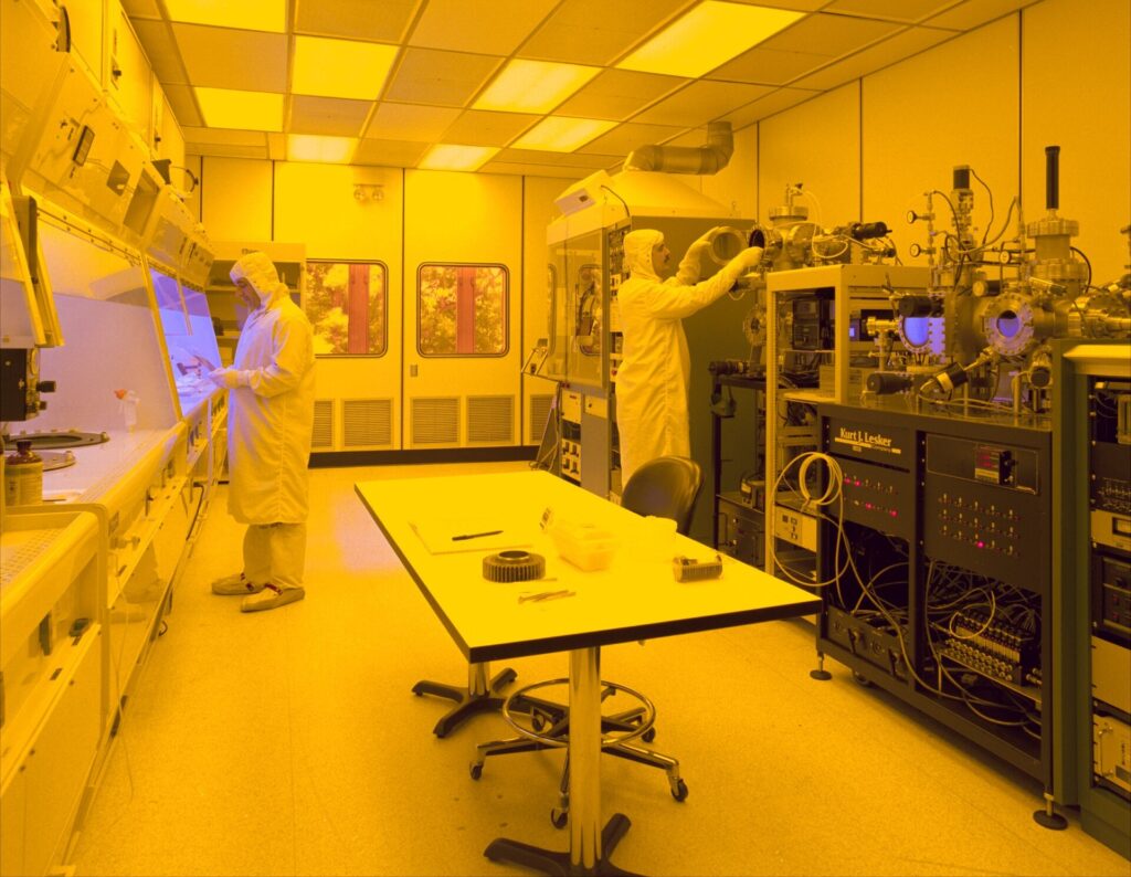 Inside the Clean Rooms Where the World’s Chips Are Born Workers in protective suits inside a semiconductor clean room
