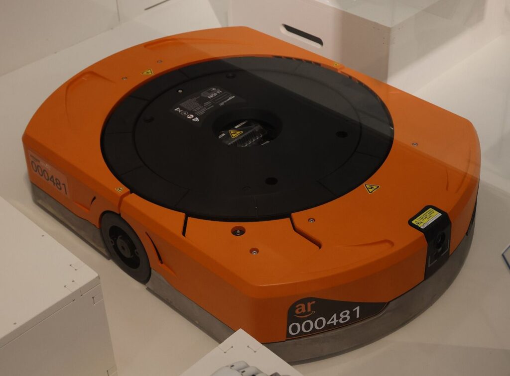 Warehouse Robots Learn to Work the Night Shift An autonomous robot moving between shelves in a warehouse