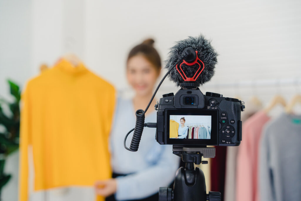How to Choose an Influencer Marketing Platform for YouTube YouTube creator filming a video with a camera on a tripod