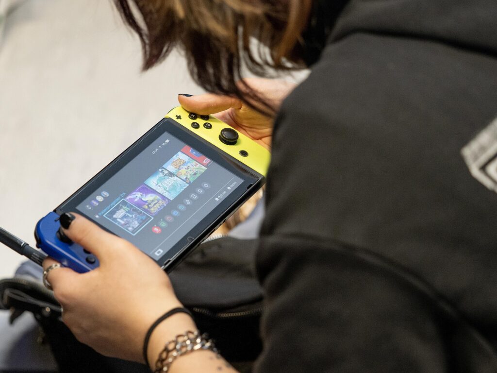 Enjoying Free Games on Browsers, Smartphones, and PlayStation Systems A person playing games on a handheld console
